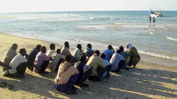 Illegal Immigrants From Somalia Wait Before Boarding A Vessel In The Port Town Of Bossaso