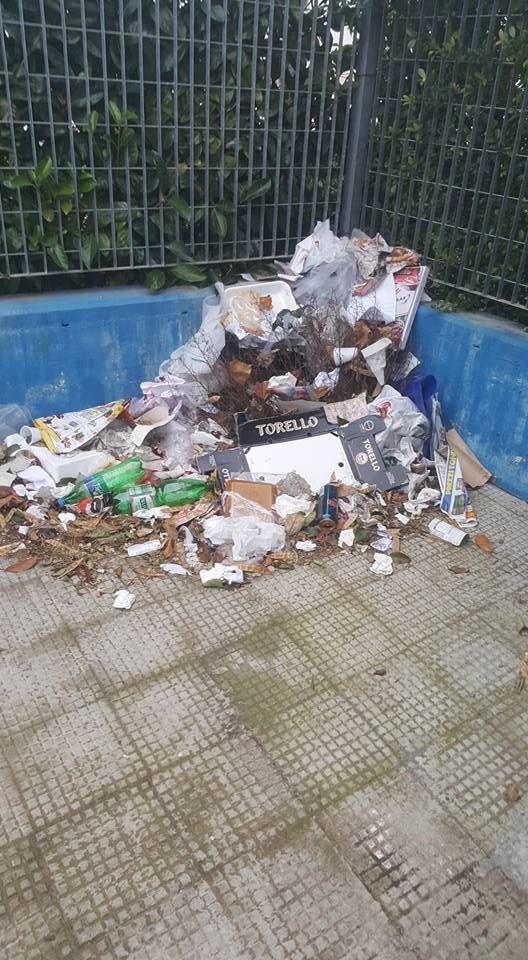 I rifiuti abbandonati nell'area antistante l'uscita della scuola