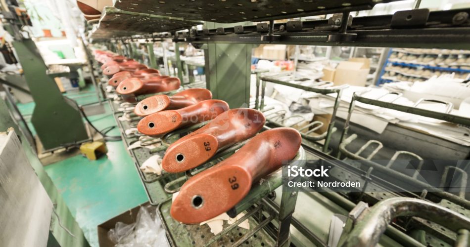 The conveyor with shoe lasts. Shoe factory, mass production of footwear.