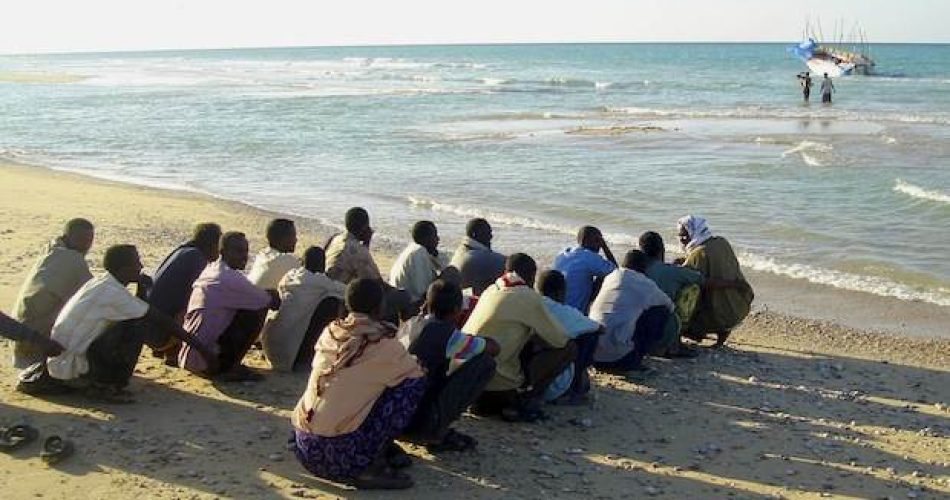 Illegal Immigrants From Somalia Wait Before Boarding A Vessel In The Port Town Of Bossaso